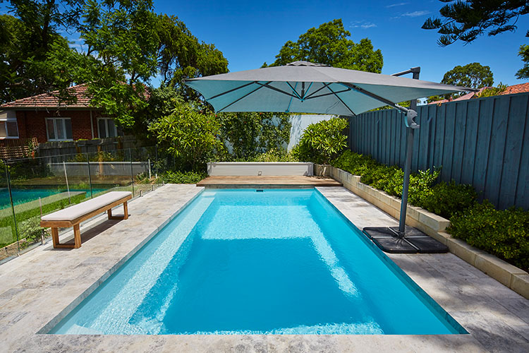 picture of hampton pool with large umbrella shading pool area